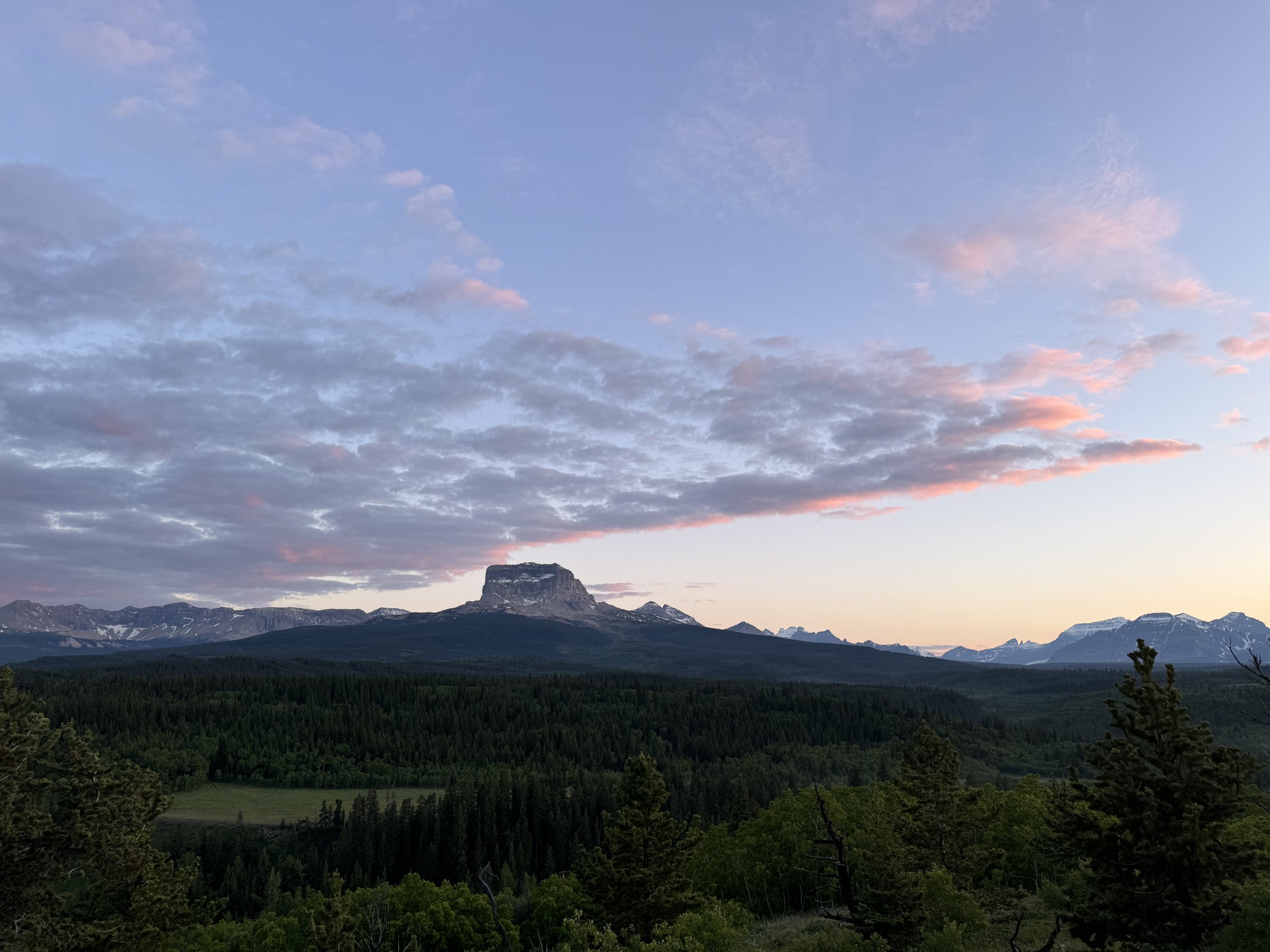 Chief Mountain at dusk under pink clouds, northern Montana